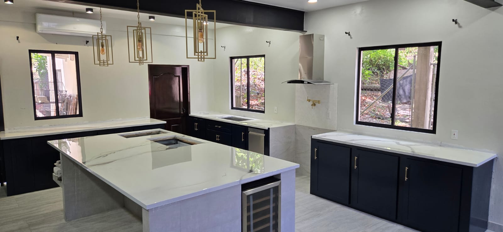 Custom kitchen cabinetry and island by E&A Furniture